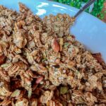 granola with nuts in bowl with spoon