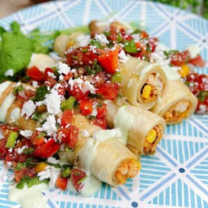 taquitos with salsa on top