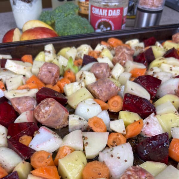 root vegetables and sausage first on baking sheet