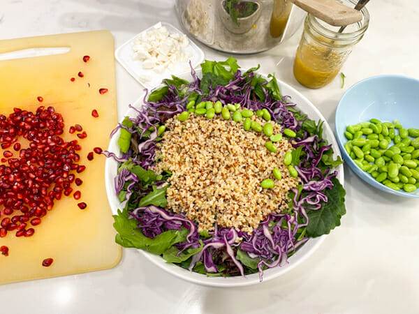 assembling pomegranate whole grain salad