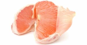 two slices of grapefruit with inner layer peeled back