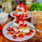 strawberry shortcake on plate with more in background