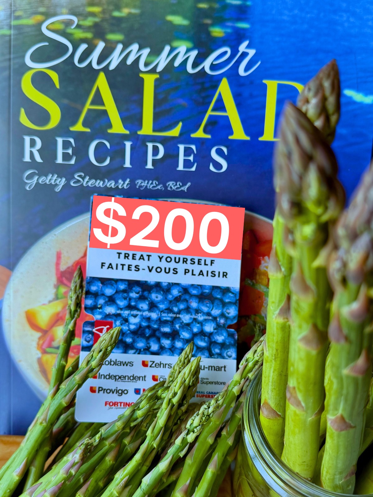 summer salad book with $200 gift card and spears of asparagus